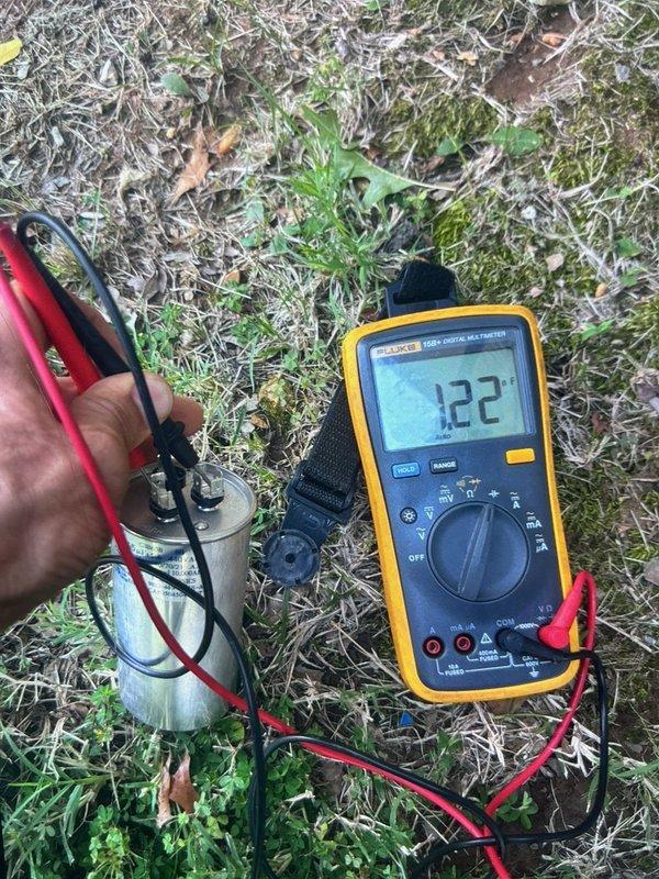 Responded to cooling complaint where system was blowing cool air but not achieving desired temperature. Performed comprehensive cooling diagnostic and discovered failed capacitor on outdoor condensing unit. Field tested capacitor with multimeter, confirming readings of 453 MFD and 122 MFD on respective terminals, both significantly outside manufacturer specifications. Replaced defective dual-run capacitor to restore proper compressor and condenser fan motor operation, returning system to normal cooling capacity.