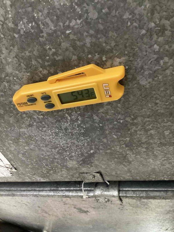 Responded to service call for water leak at indoor air handler unit located in basement. Upon arrival, found water dripping from filter access area while system maintained proper cooling operation. Inspected evaporator coil drain system and identified condensate drain line obstruction causing water overflow. Cleared blockage from drain line, verified proper drainage flow, and tested system operation to confirm leak resolved. Unit operating normally with no further water discharge at filter housing.
