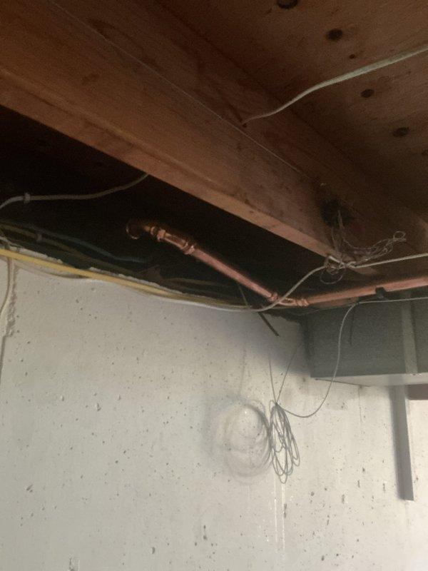 Installed new gas line from exterior meter to generator location. Routed black iron pipe along building exterior with proper support brackets and fittings, including elbows and connections as required by code. Completed interior basement connection with copper transition piping, securing all lines to floor joists and wall surfaces. All work performed to manufacturer specifications and local gas code requirements for standby generator fuel supply.