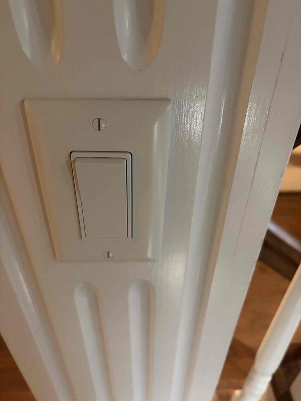 Responded to service call for defective light switch replacement. Removed existing rocker-style toggle switch from decorative paneled wall surface and installed customer-supplied replacement switch. Verified proper operation of new switch upon completion.