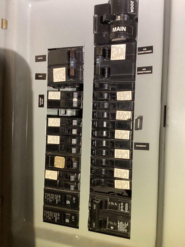 Responded to reported sparking from outlet in dining room area near overhead light fixture. Inspected electrical panel to verify circuit integrity and proper breaker operation for affected dining room circuits. Panel inspection revealed standard residential configuration with properly labeled breakers including GFCI/AFCI protection at lower positions, confirming electrical distribution system was functioning within normal parameters.