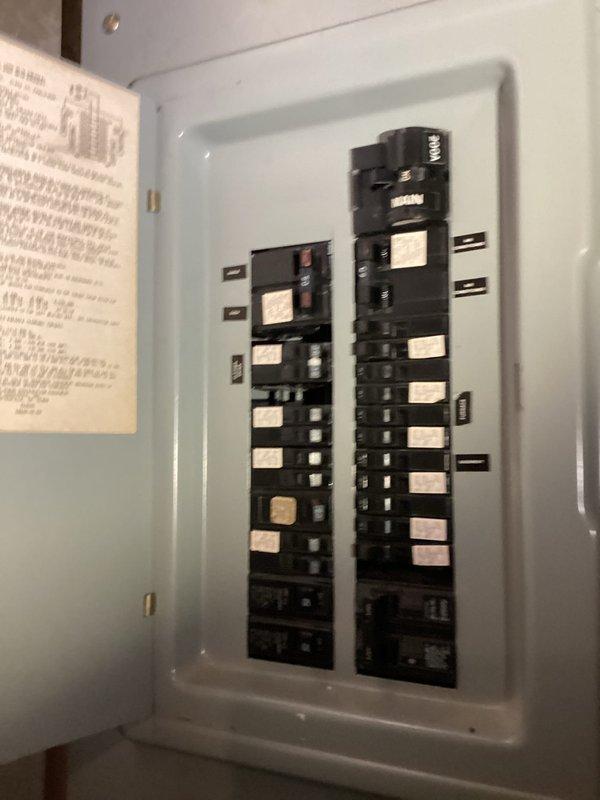 Responded to reported sparking from outlet in dining room area near overhead light fixture. Inspected electrical panel to verify circuit integrity and proper breaker operation for affected dining room circuits. Panel inspection revealed standard residential configuration with properly labeled breakers including GFCI/AFCI protection at lower positions, confirming electrical distribution system was functioning within normal parameters.