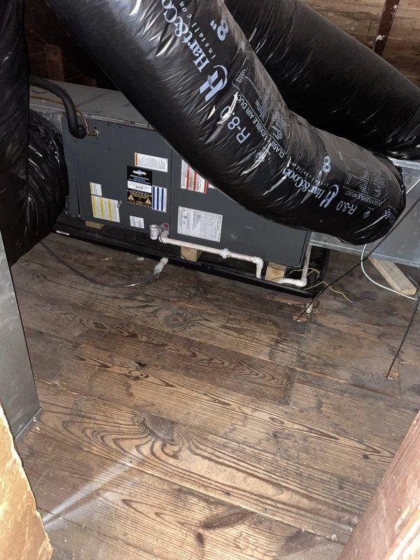 Responded to no cooling complaint on second floor. Upon arrival, found thermostat set to 74°F with current temperature reading 75°F in cooling mode, with humidity at 68%. Inspected attic-mounted air handler unit and associated ductwork system. Verified equipment operation, checked refrigerant levels, and examined condensate drainage system with white PVC piping. Photographed thermostat settings and air handler installation for service records. System restored to proper cooling operation, resolving second floor temperature issue.