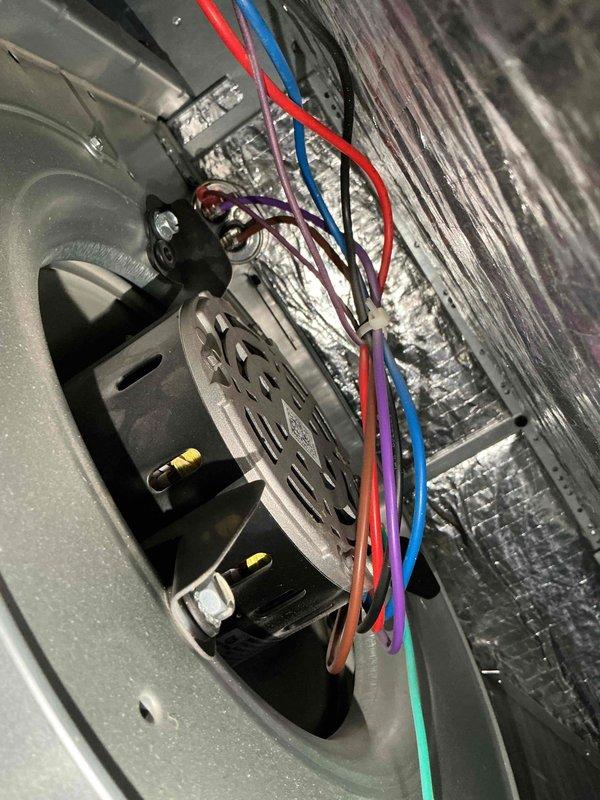Completed comprehensive cooling tune-up on residential HVAC system less than 10 years old located in side yard. Inspected and serviced blower motor assembly with multi-wire electrical connections, verified proper operation of air handler components. Documented heavily soiled condenser coil fins with significant dirt, dust, and debris accumulation requiring attention for optimal heat transfer efficiency.