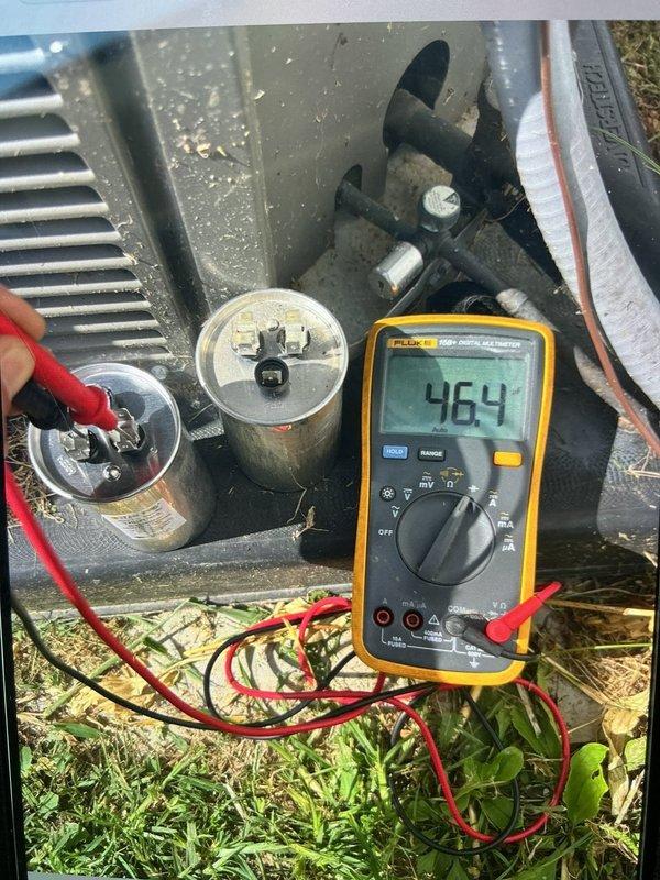Responded to no cooling complaint on U10 system blowing warm air. Upon arrival, found thermostat displaying 96°F indoor temperature. Performed diagnostic testing on outdoor unit and measured capacitor with multimeter, obtaining reading of 46.4 microfarads, indicating failed capacitor below manufacturer specifications. Identified defective run capacitor as root cause of system failure preventing compressor from operating properly.
