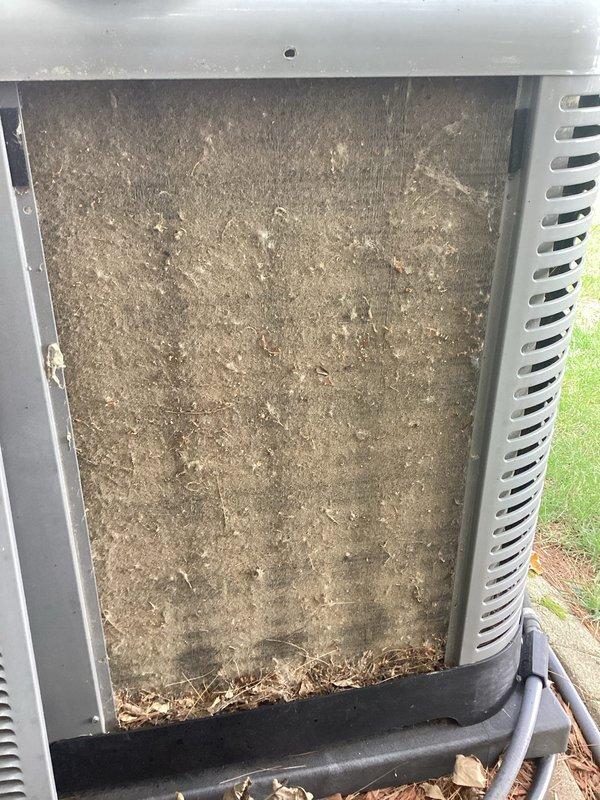 Responded to no cooling call on residential air conditioning system. Upon arrival, found outdoor unit completely inoperative with no power to compressor or condenser fan. Inspection revealed severely clogged outdoor coil and filter screen packed with heavy accumulation of dirt, dust, and debris restricting all airflow to unit. Checked electrical connections at contactor and found loose terminal connections on load side causing intermittent power loss to compressor circuit. Cleaned and tightened all electrical connections, removed debris from base pan, and cleared obstructed filter screen. Restored power to unit, verified proper compressor and fan motor operation, and confirmed system cooling normally with adequate airflow across condenser coil.