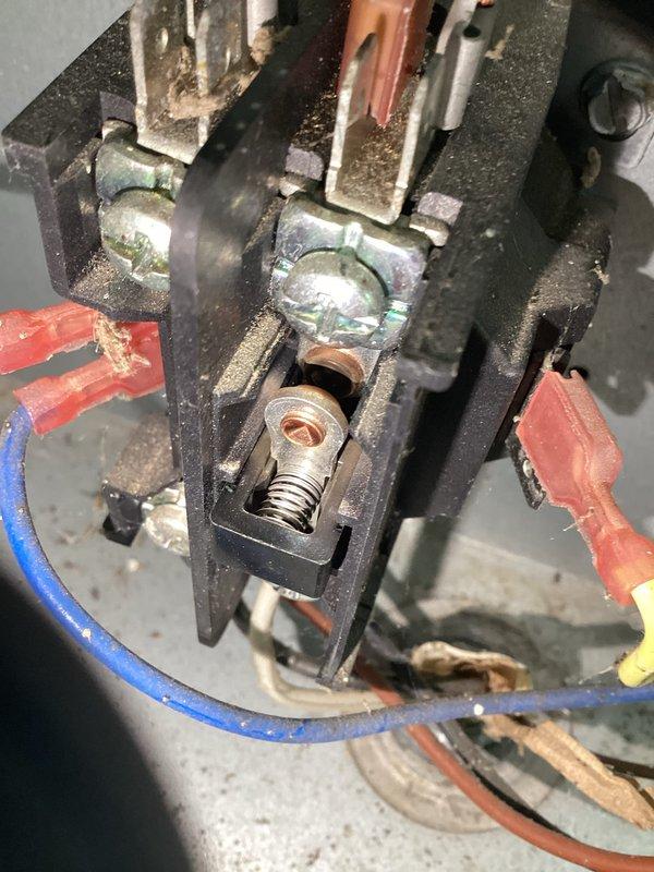Responded to no cooling call on residential air conditioning system. Upon arrival, found outdoor unit completely inoperative with no power to compressor or condenser fan. Inspection revealed severely clogged outdoor coil and filter screen packed with heavy accumulation of dirt, dust, and debris restricting all airflow to unit. Checked electrical connections at contactor and found loose terminal connections on load side causing intermittent power loss to compressor circuit. Cleaned and tightened all electrical connections, removed debris from base pan, and cleared obstructed filter screen. Restored power to unit, verified proper compressor and fan motor operation, and confirmed system cooling normally with adequate airflow across condenser coil.