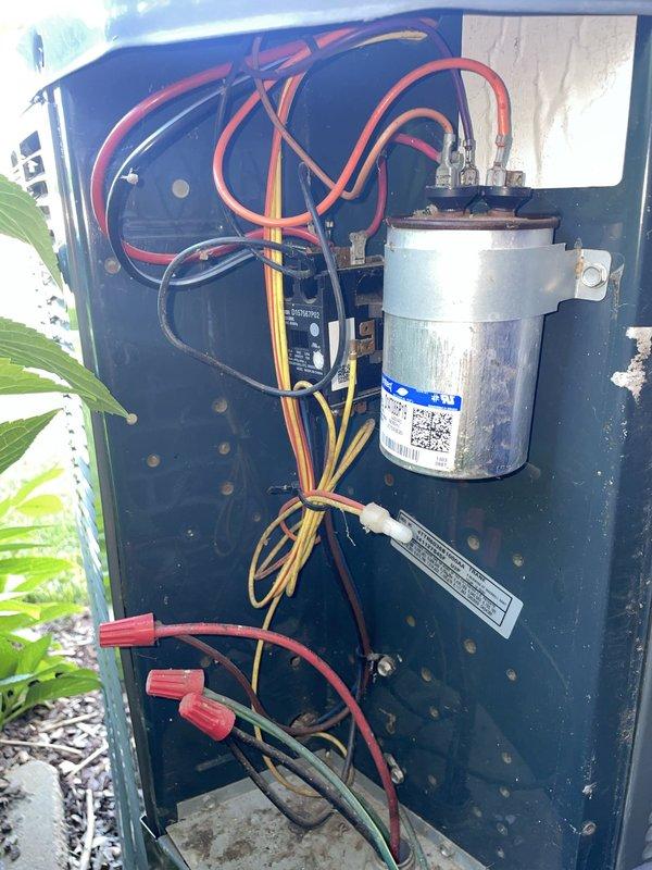 # HVAC Service - No Cool

Responded to service call for 13-year-old residential air conditioning system blowing warm air with no cooling capability. Upon arrival, verified thermostat was set to cooling mode at 90°F setpoint but system was not producing conditioned air. Proceeded to outdoor condenser unit for diagnostic inspection.

Opened electrical access panel on ground-level condenser unit and performed comprehensive visual and electrical assessment of internal components. Inspected capacitor, contactor, and associated wiring harnesses for signs of failure, damage, or degradation. Examined all wire connections, terminals, and safety devices for proper seating and continuity. Tested capacitor voltage and microfarad ratings to verify operational parameters were within manufacturer specifications.

Identified failed dual-run capacitor as root cause of no-cool condition. Component showed signs of bulging and tested significantly below rated capacitance values, preventing compressor and 