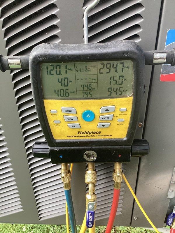 Responded to service call regarding strange chemical odor (Windex-like smell) emanating from basement HVAC unit. Performed comprehensive diagnostic inspection of Unit 010, including visual examination of internal components, electrical connections, and refrigerant lines. Accessed unit cabinet to inspect blower compartment, evaporator coil area, and condensate management system for potential leak sources. Utilized Fieldpiece SMAN refrigerant manifold gauge to measure system pressures and temperatures, verifying refrigerant charge levels and checking for signs of refrigerant leakage that could produce chemical odors. Inspected all visible copper refrigerant lines, connections, and fittings for oil residue or leak indicators. Examined condensate drain pan and drainage system for standing water, blockages, or microbial growth that may contribute to unusual odors. Verified proper operation of electrical components including contactor, transformer, and control box. Documented system conditio