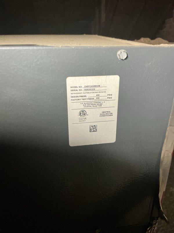 Performed leak search on second floor air conditioning system located in attic. Inspected central air conditioner air handler unit and associated components for refrigerant leaks. Documented equipment with photographs showing unit labels, model information, and installation details including condensate drain lines and unit placement on floor joists.