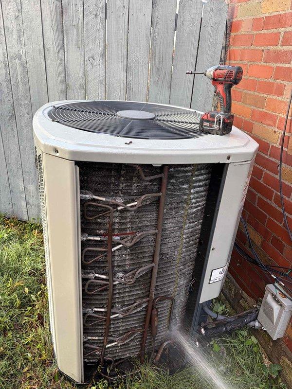 Completed comprehensive AC tune-up on single outdoor condensing unit of unknown age. Performed standard preventive maintenance including system inspection, electrical diagnostics with multimeter showing 167V reading, accessed internal components by removing front panel to inspect coil assembly and refrigerant lines. All components found to be functioning within normal parameters upon completion of routine maintenance service.
