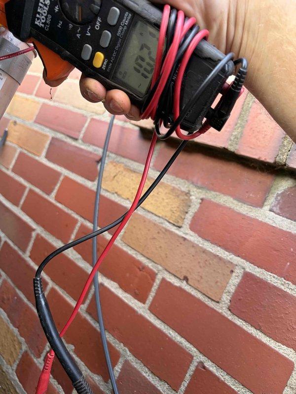 Completed comprehensive AC tune-up on single outdoor condensing unit of unknown age. Performed standard preventive maintenance including system inspection, electrical diagnostics with multimeter showing 167V reading, accessed internal components by removing front panel to inspect coil assembly and refrigerant lines. All components found to be functioning within normal parameters upon completion of routine maintenance service.