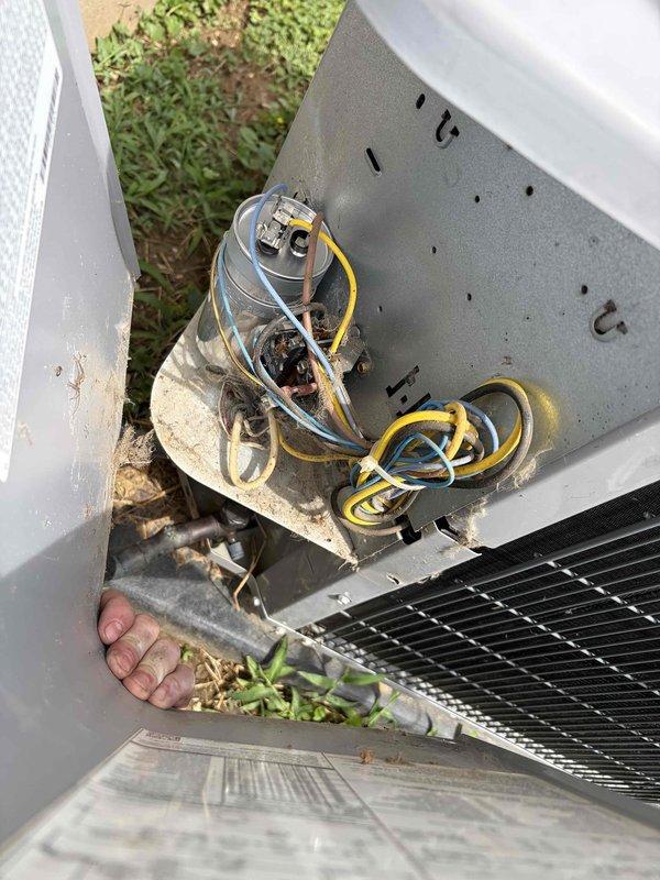 Responded to no cooling complaint on outdoor condensing unit U10 located at side of home. Upon arrival, instructed customer to turn off AC unit while leaving fan running. Performed diagnostic inspection of outdoor unit, examining capacitor with multiple wire connections (yellow, white, brown) and checking refrigerant lines. Inspected indoor air handler unit manufactured by Summit Manufacturing. Documented equipment condition with photographs showing capacitor assembly, wiring connections, and indoor unit labels including AHRI certification. Completed system evaluation and restored cooling operation.