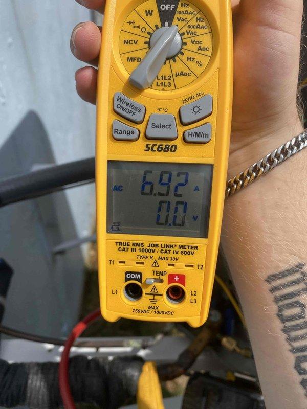 Completed comprehensive cooling system tune-up on outdoor condensing unit. Performed visual inspection of condenser coil and exterior components, verified proper fin condition and cleanliness. Measured and recorded electrical amperage draw of 6.92A on compressor circuit, confirming unit operating within normal parameters.