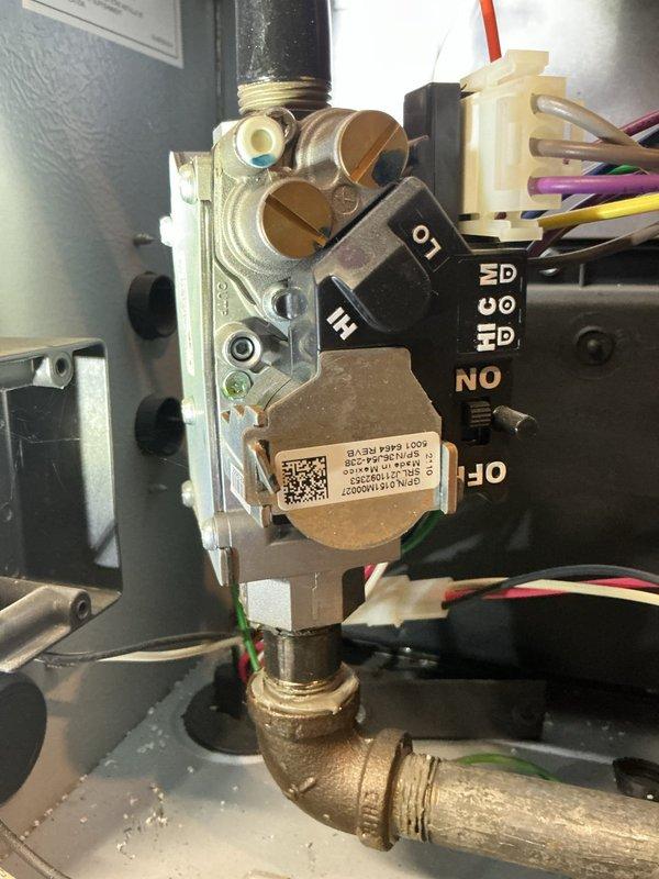 Responded to gas leak emergency in basement furnace system where utility company had shut off gas supply. Performed comprehensive inspection of gas valve assembly and associated connections to locate source of leak. Documented furnace conditions and gas valve components with detailed photography for safety records and further assessment.