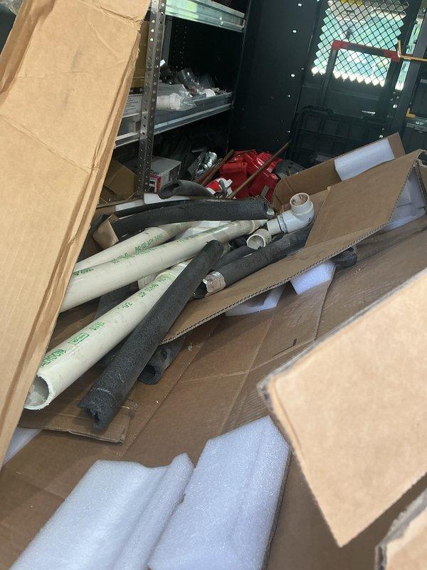 Responded to site for material retrieval from previous installation. Collected and removed remaining construction debris from basement, including PVC pipe sections, fittings, pipe insulation foam, and cardboard packaging materials left from prior service call. Materials documented photographically and removed from premises.