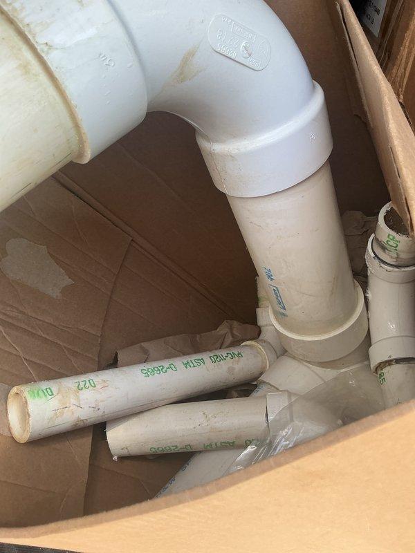 Responded to site for material retrieval from previous installation. Collected and removed remaining construction debris from basement, including PVC pipe sections, fittings, pipe insulation foam, and cardboard packaging materials left from prior service call. Materials documented photographically and removed from premises.