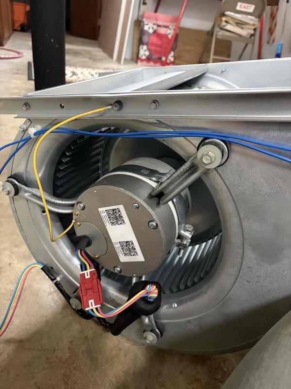 Replaced defective blower motor, drive, and wheel assembly on HVAC unit under warranty coverage. Removed failed motor assembly from metal housing unit, disconnected all electrical connections, and installed new Lennox replacement motor with mounting brackets and squirrel cage fan housing. Verified proper belt alignment, secured all wiring connections, and retained original parts per warranty requirements.