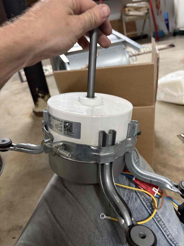 Replaced defective blower motor, drive, and wheel assembly on HVAC unit under warranty coverage. Removed failed motor assembly from metal housing unit, disconnected all electrical connections, and installed new Lennox replacement motor with mounting brackets and squirrel cage fan housing. Verified proper belt alignment, secured all wiring connections, and retained original parts per warranty requirements.