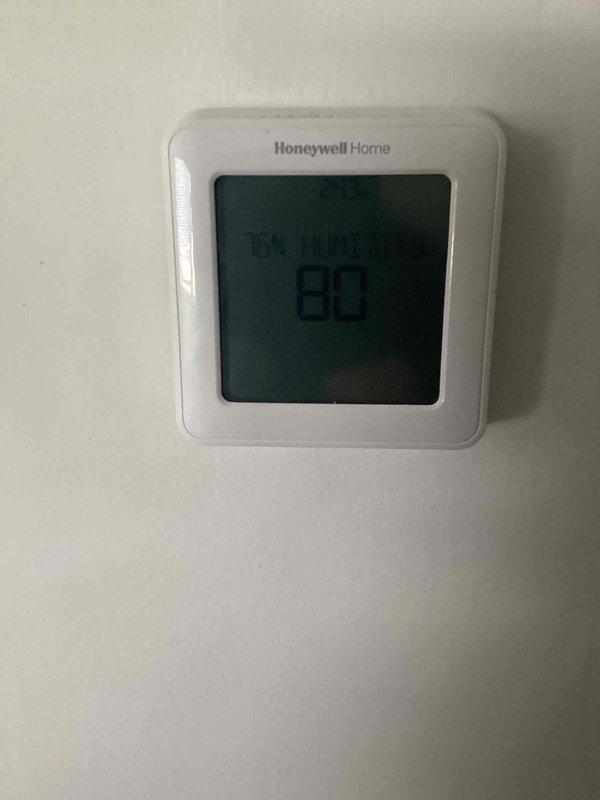 Responded to no-cool emergency call for residence with small children and indoor temperature at 90 degrees. Upon arrival, found 10+ year old ground-level unit blowing warm air with active water leak. Confirmed system had been turned off per prior instructions with fan left in circulation mode. Performed diagnostic evaluation of both indoor air handler and outdoor condensing unit. Identified refrigerant leak causing loss of cooling capacity and resulting condensate drainage issue. Documented thermostat reading of 80 degrees at time of service and captured equipment condition photos showing furnace, air handler assembly, refrigerant lines, and overall installation in basement mechanical room.