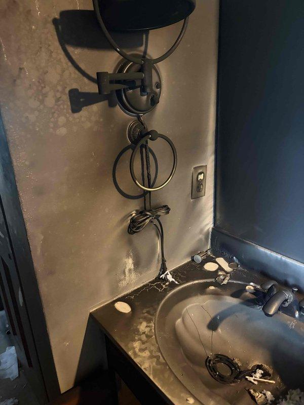 Conducted on-site electrical assessment for complete home rewire following fire damage. Evaluated existing electrical infrastructure throughout residence, including second-floor landing area where ceiling-mounted fixture locations require new wiring installations and proper junction box placements. Assessed bathroom electrical requirements, including wall sconce fixture wiring and switch placement for vanity lighting. Documented current conditions of unfinished walls and exposed wiring to develop comprehensive electrical restoration bid for fire-damaged property.