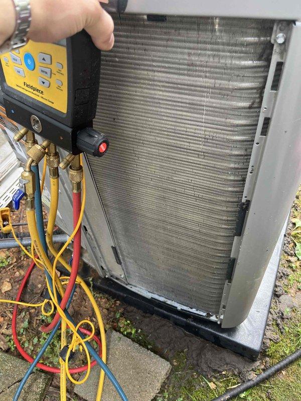 Completed comprehensive tune-up service on both Lennox air conditioning and furnace systems, approximately 2-3 years old. Performed full diagnostic testing on outdoor condensing unit using digital manifold gauges to verify refrigerant charge levels and system pressures. Inspected condenser coil condition, confirmed clean fins and proper airflow. Connected refrigerant service hoses to measure system performance and ensure optimal operation. Conducted indoor equipment inspection and maintenance procedures. Both heating and cooling systems found operating within manufacturer specifications with no issues identified.