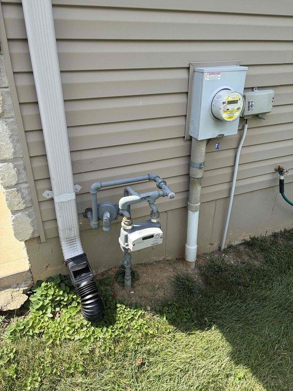 Conducted comprehensive site evaluation for backup generator installation. Documented existing 200-amp electrical service panel with multiple circuit configurations and assessed exterior utility connections including meter base, service entrance conduit, and gas line infrastructure to determine optimal generator integration point and transfer switch placement requirements.