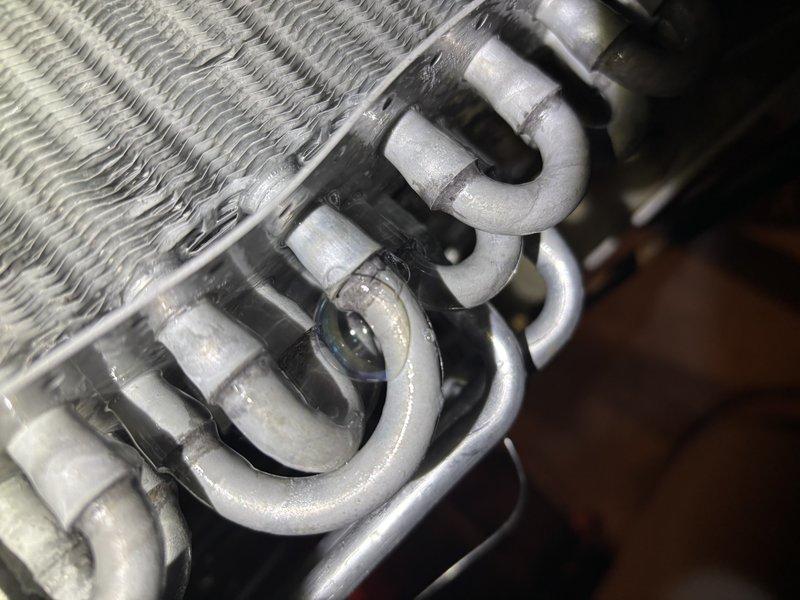 Responded to no cooling complaint on 4-year-old Lennox air conditioning system. Upon arrival, confirmed unit was running but blowing warm air with no cooling output. Performed system diagnostics and inspected evaporator coil assembly. Found evaporator coil heavily contaminated with dust and debris accumulation, restricting airflow and reducing heat transfer efficiency. Inspected refrigerant lines and U-bend connections at coil assembly, which showed normal operational wear. Documented coil condition with photos showing significant fin blockage and surface contamination on aluminum fins. Recommended thorough evaporator coil cleaning to restore proper airflow and cooling capacity. System requires coil maintenance to resolve warm air issue and return unit to normal cooling operation.