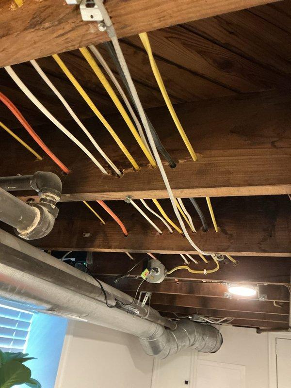 Completed comprehensive whole-home electrical inspection as part of recurring maintenance service. Inspected exposed basement ceiling electrical infrastructure, including multiple circuit wiring runs, junction boxes, and connections to verify proper installation and code compliance. Examined older electrical disconnect panel with cartridge fuses, noting age-related deterioration of cable insulation and accumulated dust within enclosure, documented all findings with photographic evidence for maintenance records.