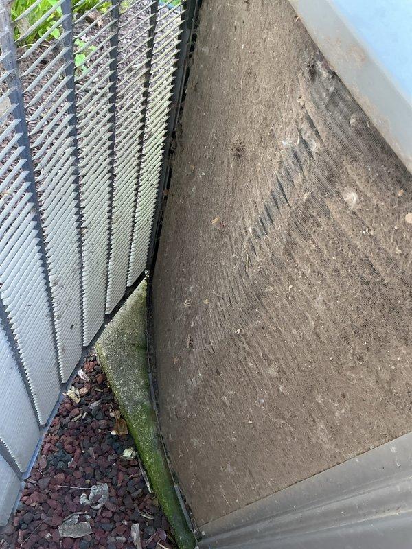Responded to no cooling call for 10-year-old outdoor unit located at side of home. Upon arrival, confirmed unit was not operating despite customer cycling breaker multiple times. Performed electrical diagnostics using clamp meter to test voltage and amperage at condensing unit. Inspected outdoor unit installation area, noting moisture accumulation and algae growth at foundation level which may contribute to electrical issues. Identified primary failure preventing unit operation and provided repair options to restore cooling system functionality.
