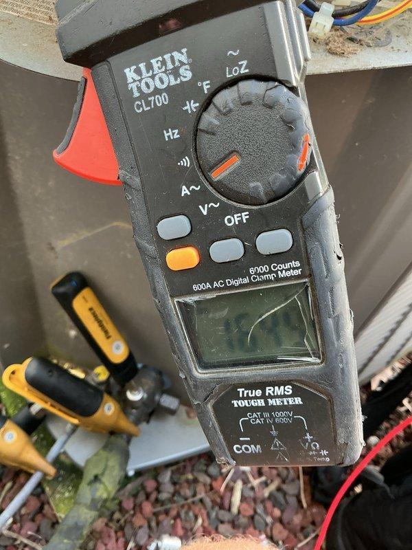 Responded to no cooling call for 10-year-old outdoor unit located at side of home. Upon arrival, confirmed unit was not operating despite customer cycling breaker multiple times. Performed electrical diagnostics using clamp meter to test voltage and amperage at condensing unit. Inspected outdoor unit installation area, noting moisture accumulation and algae growth at foundation level which may contribute to electrical issues. Identified primary failure preventing unit operation and provided repair options to restore cooling system functionality.