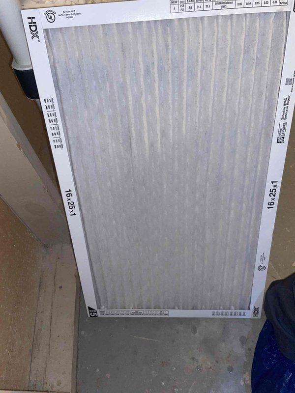 Responded to callback for musty odor complaint on cooling unit less than one year old located in side yard. Upon inspection, found condensate drain line improperly installed with inadequate pitch and foam insulation blocking proper drainage. Cleared condensate line, verified proper drainage flow, and replaced dirty air filter with new HDX 16x25x1 pleated filter. System tested and operating normally with no odor present at time of departure.