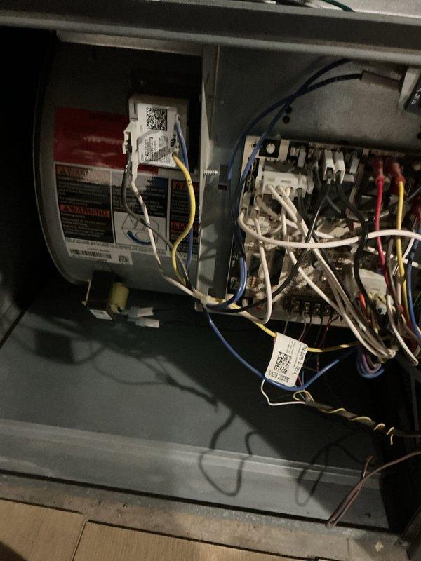 Completed preventative maintenance tune-up on first of two residential AC units at duplex property, with system age approximately 11 years. Performed comprehensive inspection of indoor air handler components including electrical connections, wiring harnesses, and control board; verified all wire terminations secure and properly routed. Inspected and documented air filter condition, noting standard quilted media filter in place within unit housing.