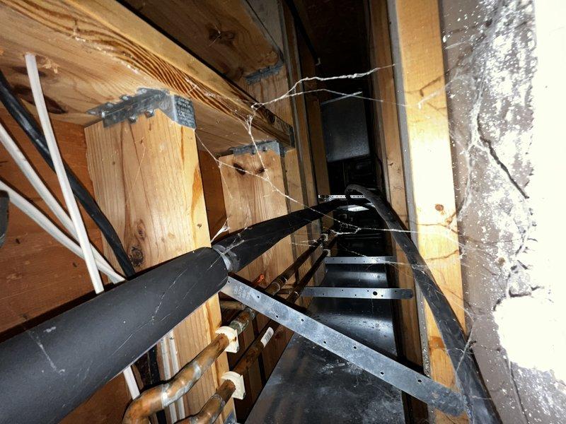 Continued refrigerant leak search on recently installed system. Accessed attic space and inspected HVAC air handler unit and associated ductwork connections. Performed thorough visual inspection of evaporator coil housing, refrigerant line connections, and accessible ductwork joints for signs of refrigerant leak. System currently operational with heat and cooling functions confirmed working at time of service.