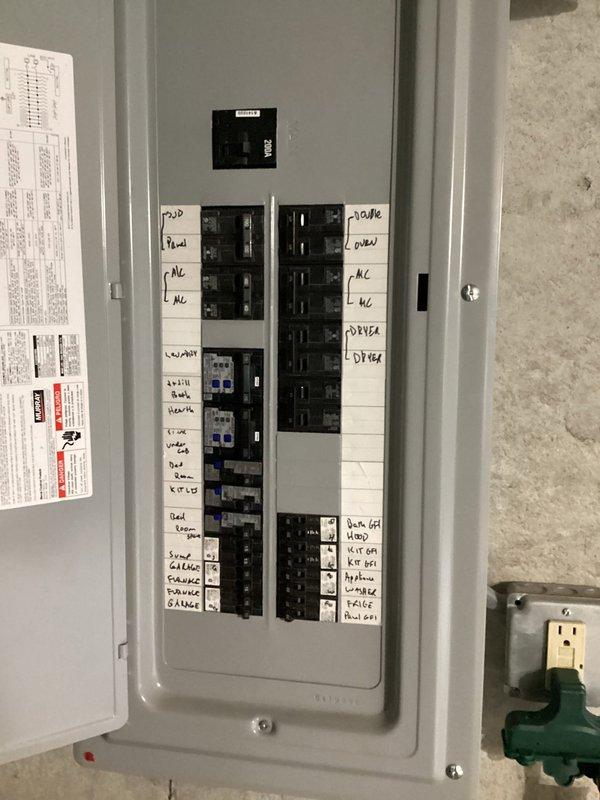 Responded to service call for tripping 12-4 breaker affecting first floor ceiling fan operation. Inspected main electrical panel in basement and identified circuit feeding affected fixture. Documented panel configuration showing multiple circuits with handwritten labels for various zones including HVAC, laundry, bedrooms, and kitchen appliances. Verified proper breaker sizing and connections, checked for loose terminations or signs of overheating at breaker terminals. Tested circuit integrity and confirmed breaker functionality, ensuring proper amperage rating for connected load and safe operation of ceiling fan circuit.