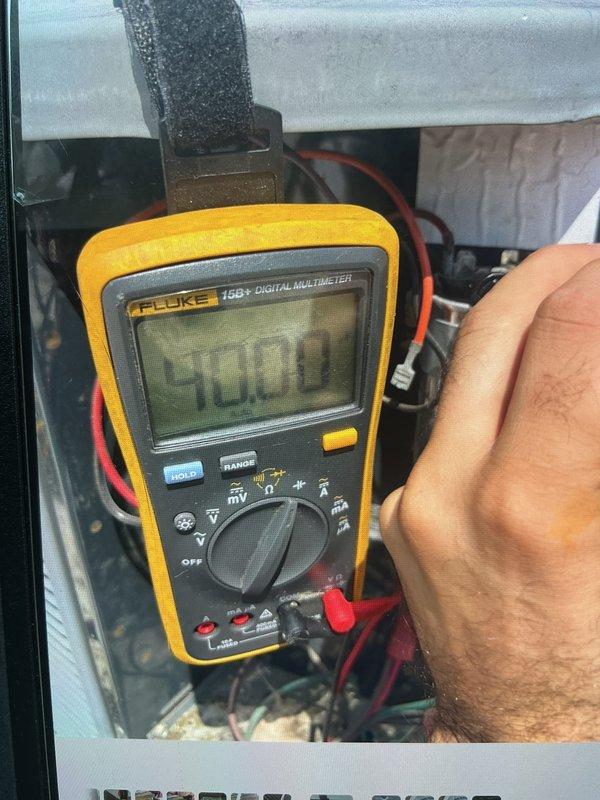 Completed cooling maintenance on single rooftop HVAC unit. Performed comprehensive system inspection including electrical testing with multimeter showing 50.0V reading, verified gas burner assemblies and ignition components, inspected control board connections and wiring integrity. All components operating within normal parameters; system ready for cooling season.