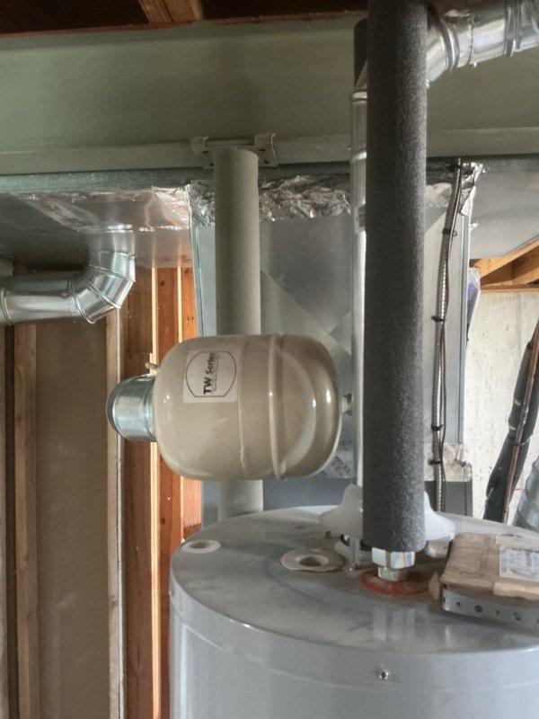 # HVAC Service Completed

Responded to service call for reported damage to flue pipe on residential HVAC system located in utility closet. Upon arrival, inspected Lennox furnace/air handler unit less than 10 years old. Observed significant condensation accumulation on metallic flexible ductwork, indicating potential airflow or insulation issues in addition to the reported flue damage. 

Examined flue pipe assembly and confirmed penetration damage as reported. Assessed surrounding HVAC components including copper refrigerant lines, brass service valves, and insulated piping for any additional concerns. Documented equipment condition with photographic evidence showing moisture issues on ductwork and overall system configuration.

Evaluated water heater and expansion tank in same utility area to ensure flue damage had not affected other mechanical systems. Inspected foam-insulated piping and verified proper clearances between all equipment.

Provided customer with repair estimate to addre