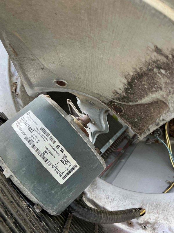 Responded to no cooling complaint on 16-year-old air conditioning system. Upon arrival, confirmed outdoor unit was completely unresponsive with no operational sounds or compressor activity. Performed diagnostic inspection of condenser unit and identified failed condenser fan motor. Motor showed no electrical continuity and exhibited signs of age-related deterioration consistent with equipment lifespan. Documented existing conditions including dirt accumulation and environmental wear on unit components. Replaced defective condenser fan motor with new OEM-equivalent component, restored electrical connections, and verified proper system operation. Unit now cycling normally with compressor engaging and condenser fan running at proper speed.