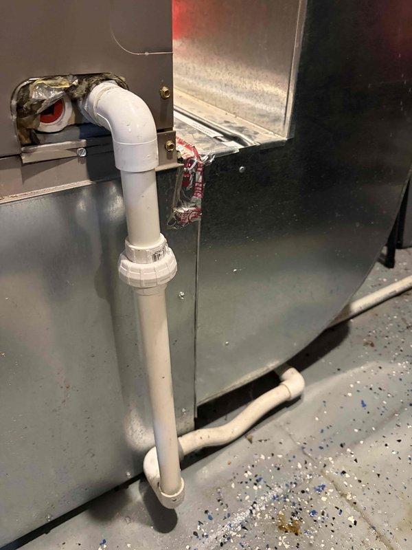 Responded to report of water leakage from AC unit located in basement. Upon inspection, identified clogged condensate drain line as source of water leak. Cleared blockage from PVC drainage system and verified proper flow through drain assembly. Tested unit operation to confirm condensate is draining properly with no further leakage detected.