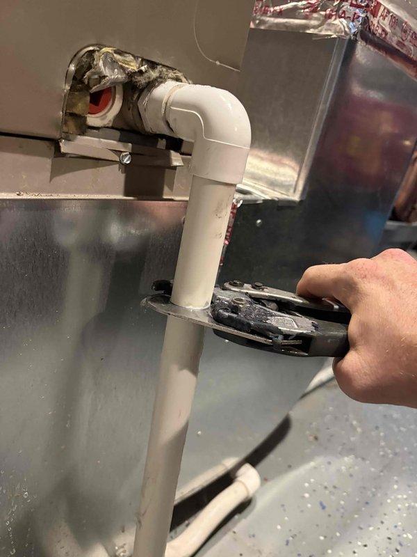 Responded to report of water leakage from AC unit located in basement. Upon inspection, identified clogged condensate drain line as source of water leak. Cleared blockage from PVC drainage system and verified proper flow through drain assembly. Tested unit operation to confirm condensate is draining properly with no further leakage detected.