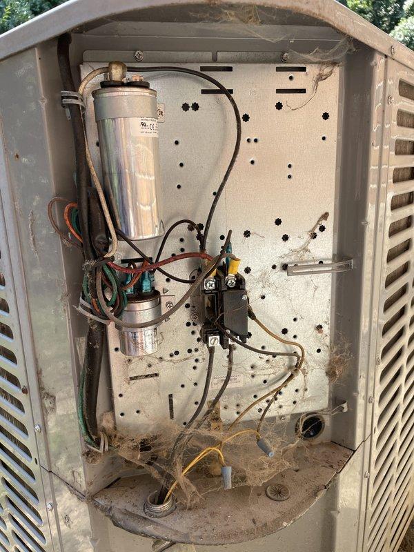 Responded to cooling failure on 15-year-old residential air conditioning system with reported 10-degree temperature differential between setpoint and actual indoor temperature. Upon arrival, performed diagnostic evaluation of outdoor condensing unit and indoor evaporator coil. Measured supply air temperature at evaporator coil, recording 50°F discharge temperature. Inspected outdoor unit electrical components including dual run capacitors and contactor assembly. Found unit operational but with reduced cooling capacity due to accumulated debris and contamination within condensing unit cabinet affecting airflow and heat transfer efficiency. Cleaned condenser coil fins, removed spider webs and debris from electrical compartment, and verified proper capacitor values and contactor operation. System restored to normal operating parameters with improved temperature differential.