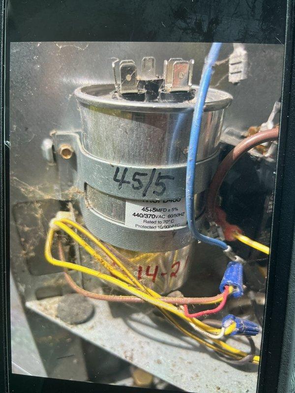 Responded to no cooling complaint on backyard HVAC unit U10. Upon arrival, found unit had been shut off with only fan operating. Diagnosed failed dual run capacitor showing 44.5 MFD on 45/5 MFD rated component, which was below acceptable tolerance and causing compressor failure to start. Removed defective TITAN capacitor and replaced with new 45/5 MFD 440V dual run capacitor rated to 70°C with 165°F thermal protection. Verified proper electrical connections on common, hermetic, and fan terminals. Tested new capacitor with multimeter confirming proper capacitance reading of 45.4 MFD. Restored power to unit, verified compressor startup, and confirmed system cooling properly with normal operation restored.