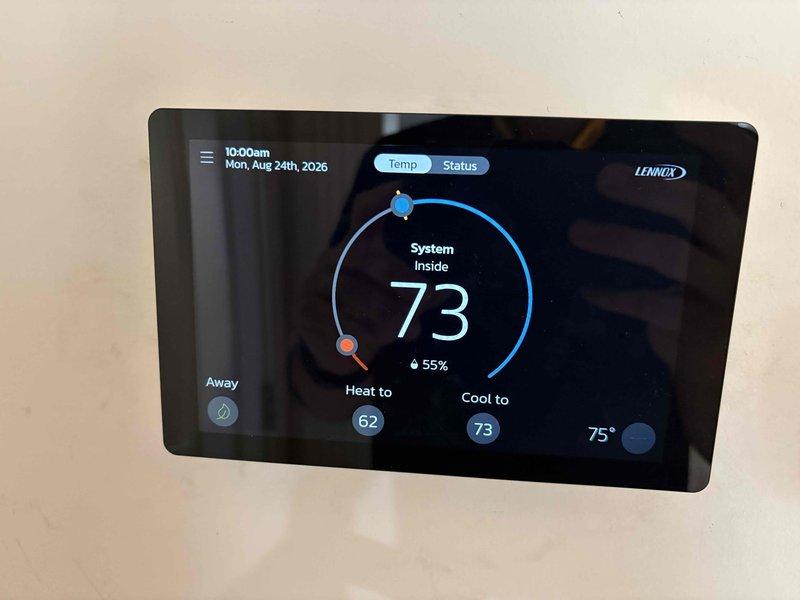 Completed comprehensive AC tune-up on 2-year-old Lennox heat and air system with no reported issues. Performed full system inspection, verified thermostat operation and programming on Lennox digital control displaying proper temperature settings and humidity levels, and installed new Filterbuy pleated air filter. All components operating within normal parameters; system maintaining efficient performance with no deficiencies noted.