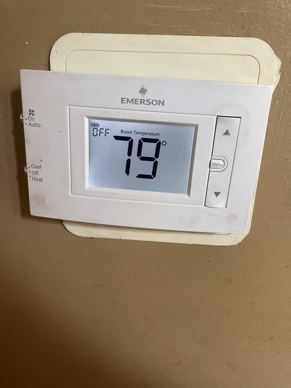 Responded to no cooling complaint on Unit 10 located at side of home. Upon arrival, inspected control board and thermostat system. Found thermostat displaying 79°F with system in OFF mode. Examined Emerson digital thermostat controls and verified proper display function. Inspected main control board assembly including circuit board components, relays, capacitor, and wire harness connections. Instructed occupant to turn OFF AC unit and leave fan ON/running for system protection. Documented control board and thermostat conditions with photos for service records.