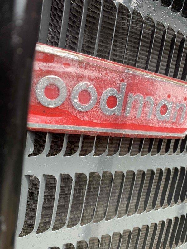 Completed comprehensive tune-up and maintenance service on Goodman HVAC system located at rear of property. Performed standard preventive maintenance protocol including inspection of heat exchanger, condenser coil with aluminum fins, and refrigerant lines. System was operational upon arrival and showed normal condensation patterns consistent with active cooling cycle, with unit displaying appropriate frost accumulation on components indicating proper refrigerant flow and heat exchange function.