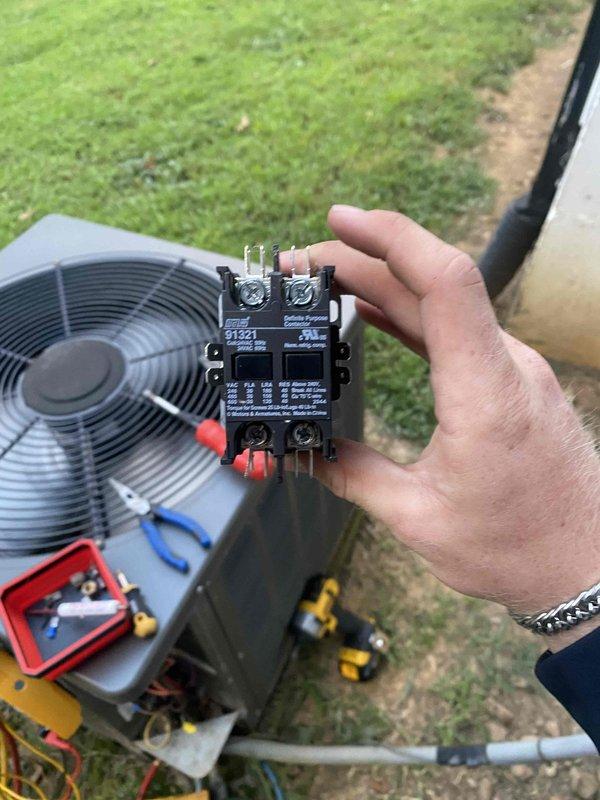Responded to no cooling complaint on 10+ year old system located at ground level in basement area. Diagnosed failed contactor on outdoor condensing unit preventing compressor operation. Tested and confirmed contactor coil reading 6.3 ohms, indicating electrical failure. Removed defective contactor and advised customer to shut off AC system and leave fan running until replacement part could be installed to prevent further system damage.