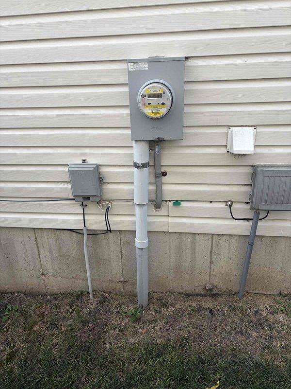 Completed installation of customer-provided thermostat in 4-year-old residential property. Verified whole house electrical system functionality, including main service panel with properly labeled circuit breakers controlling HVAC, dryer, hot tub, and other household circuits. Confirmed exterior meter installation and service entrance conduit configuration met code requirements prior to proceeding with thermostat installation as requested.