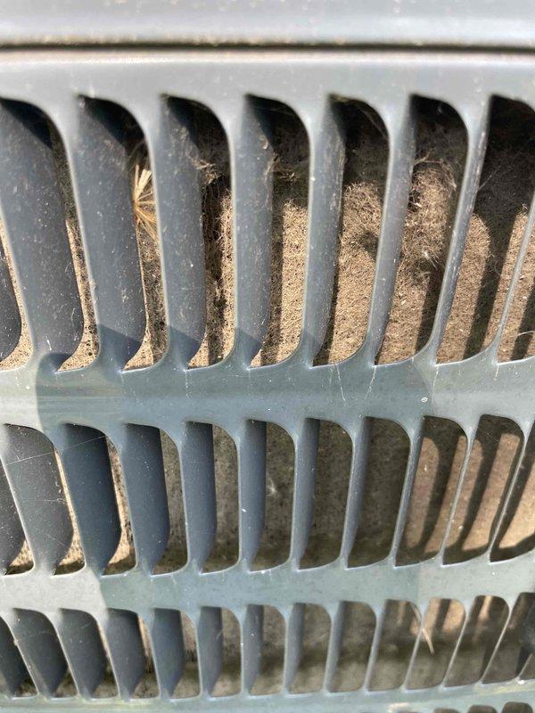 Completed comprehensive tune-up service on two residential air conditioning systems. Upon arrival, found outdoor condensing unit with significant dirt accumulation and debris around equipment perimeter. Performed thorough inspection of both units, including visual assessment of condenser coils which revealed heavy buildup of dust, lint, and particulate matter restricting airflow through fin structure. Cleaned condenser coils to restore proper heat transfer efficiency and checked all electrical connections. Verified refrigerant lines, tested system operation, and cleared surrounding area of leaves and organic debris to ensure adequate ventilation clearance around equipment.