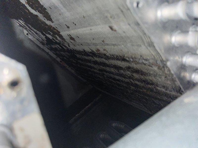 Responded to ongoing no cooling complaint on unit U10 in side yard. Previous technicians had rewired thermostat, but system continued to fail to produce cold air since late April/early May. Upon arrival, performed comprehensive diagnostic evaluation of air conditioning system.

Inspection revealed severely compromised airflow due to extensive contamination of critical heat exchange components. Evaporator coil showed heavy accumulation of dust, dirt, and biological growth throughout fin surfaces, significantly restricting air passage and heat transfer capability. Condenser coil similarly affected with dense particulate matter lodged between fins, creating blockage that prevented proper heat rejection. Ductwork exhibited substantial debris buildup along seams and interior surfaces, indicating poor air quality and inadequate system maintenance over extended period.

Documented conditions with photographic evidence showing extent of contamination on both evaporator and condenser coils. The