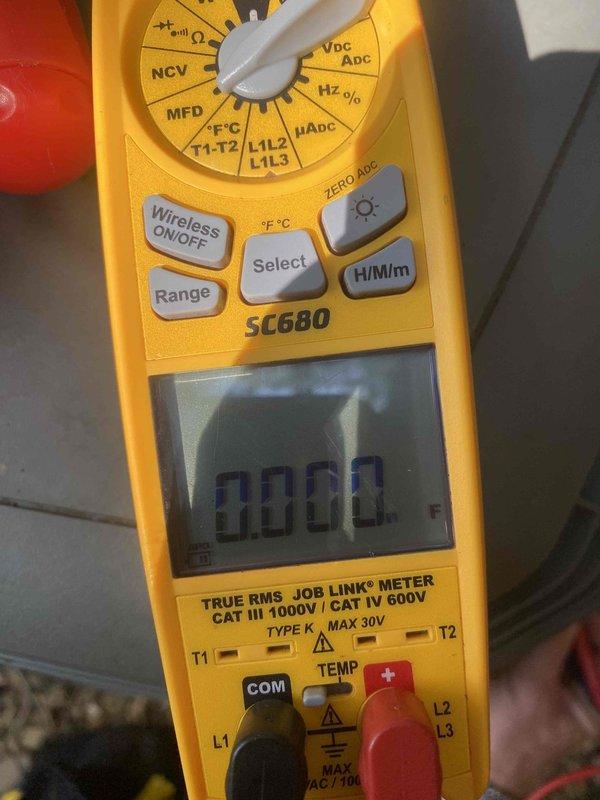 Responded to no cooling call where customer reported system blowing hot air with outdoor unit not operating. Upon arrival, performed electrical diagnostics on 10-year-old split system located in basement with condensing unit at ground level behind residence. Used digital multimeter to test compressor amperage draw and capacitor values, revealing electrical failure preventing outdoor unit operation. Diagnosed faulty run capacitor reading 499.1 MFD, significantly outside manufacturer specifications, causing compressor lockout and loss of cooling capacity. Advised customer of findings and provided repair options to restore system functionality.